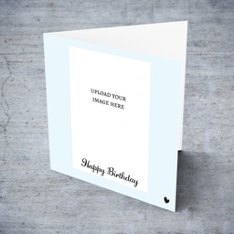 Light blue background photo birthday card in English with small black heart 