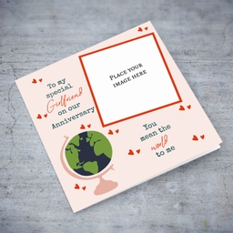 A romantic photo anniversary card for Girlfriend - You mean the world to me - in light pink background, scattered hearts and a globe in English