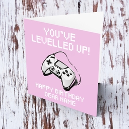 Game console in pixellated text, pink background birthday card in English (Personalisable)