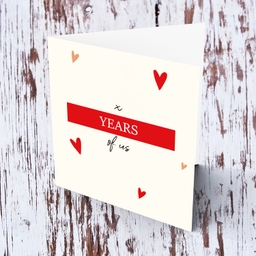 Number of years of us - anniversary minimalist card with scattered hearts in English