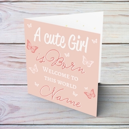 A cute baby girl is born - New born greeting card for girls in light pink background and scattered butterflies in English