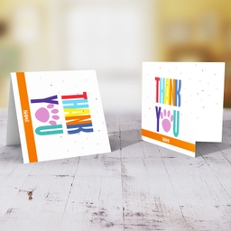 Colourful thank you card with paw print and scattered hearts in English