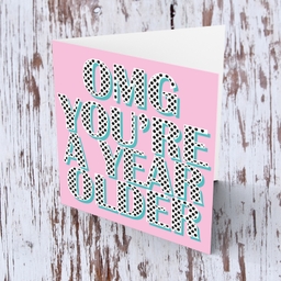 Pink background with polka dot wording you're a year older birthday card in English