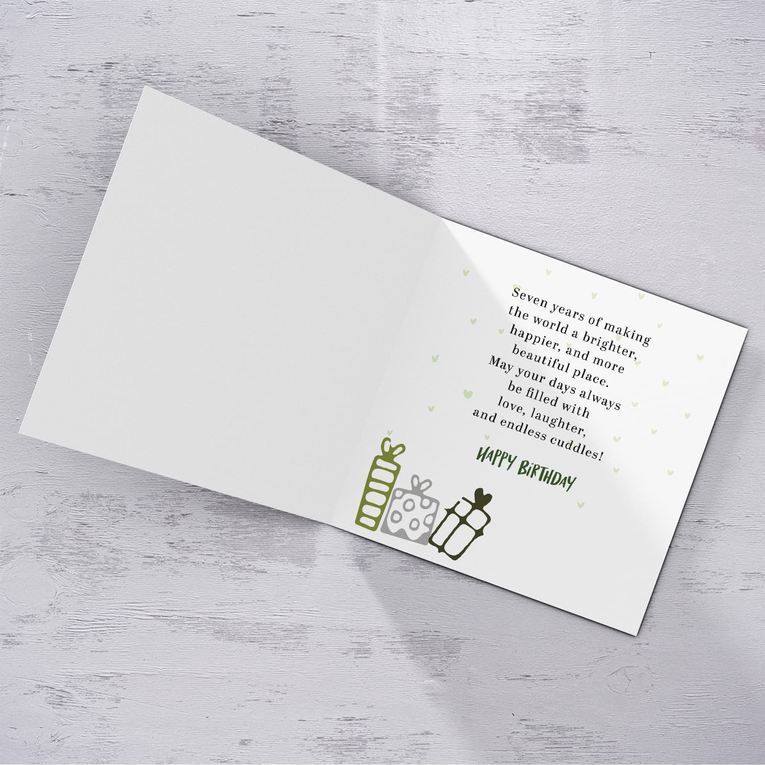 A cute football themed photo birthday card for a 7 year old boy, featuring a green themed background, with scattered footballs in English