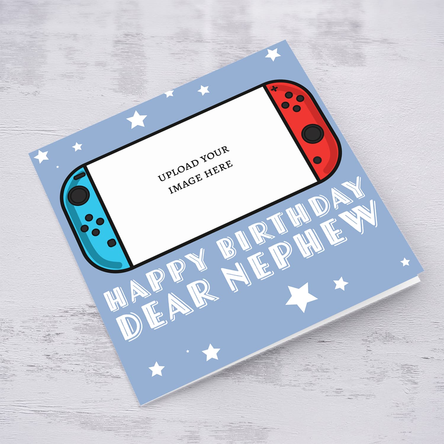 A photo birthday card for nephew featuring a nintendo cartoon design, in a light blue background with scattered white stars in English