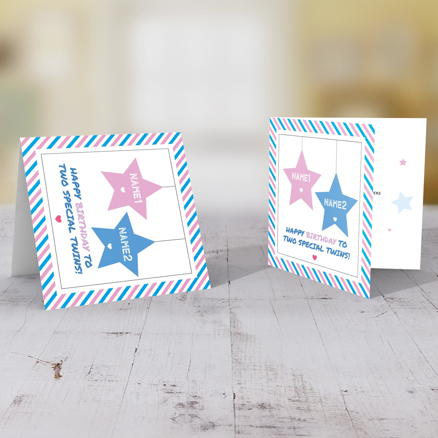 Twins birthday card with 2 hanging stars in pink and blue and striped border in English (Personalisable)