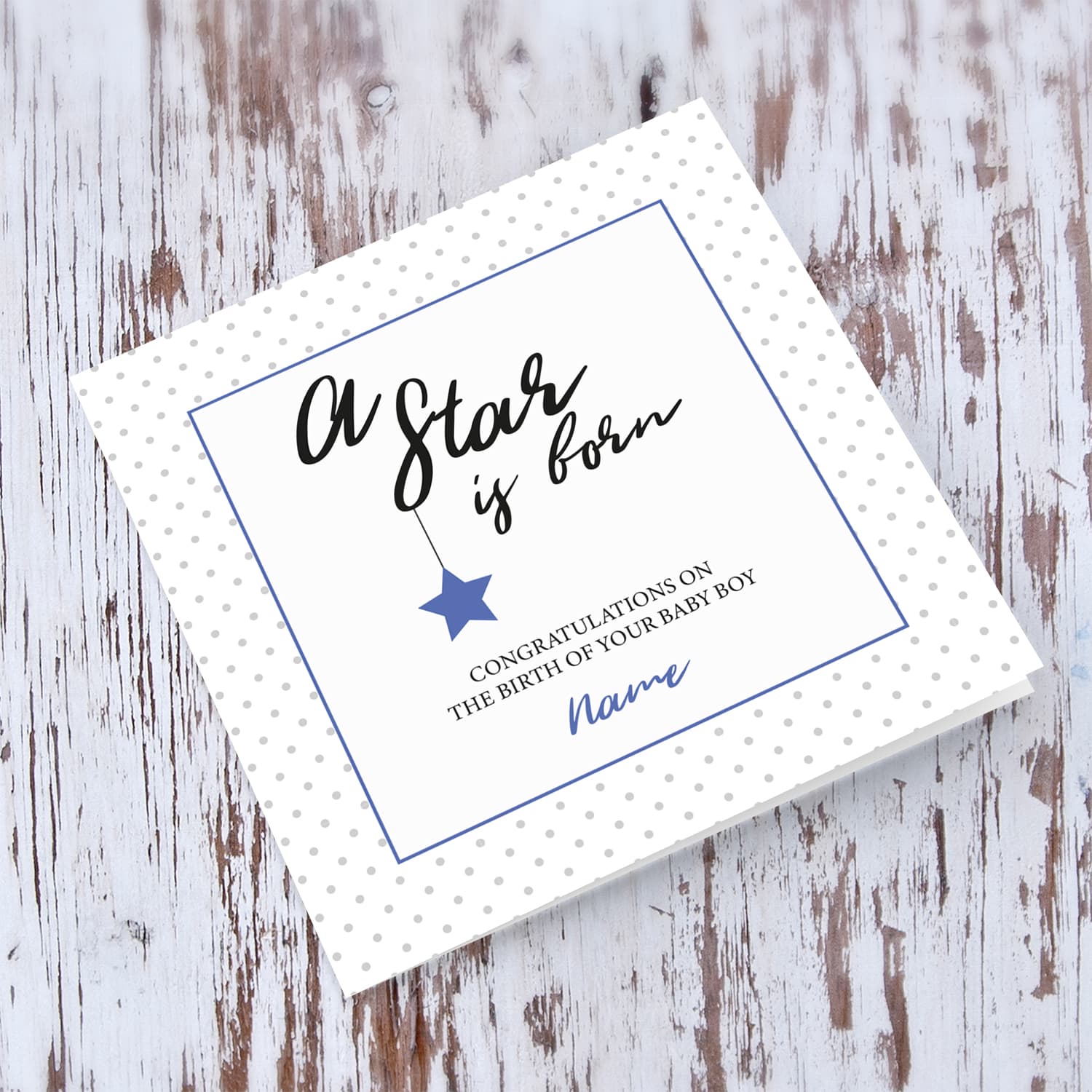 New born personalisable card for boys with polka dotted background and blue square with star in English