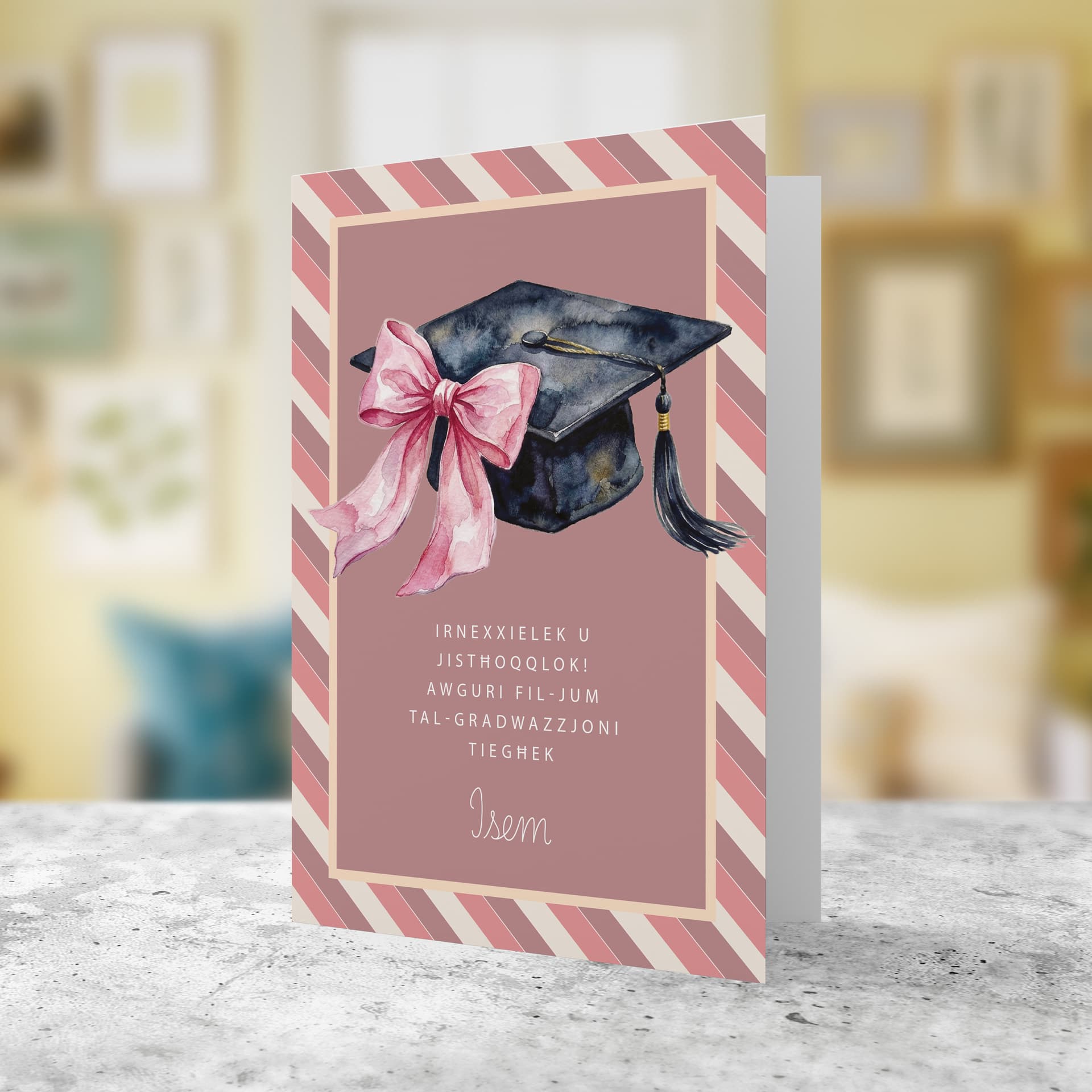A beautiful A5 graduation card for females in a striped background, featuring a graduation hat with a cute pink bow in Maltese (Personalisable)