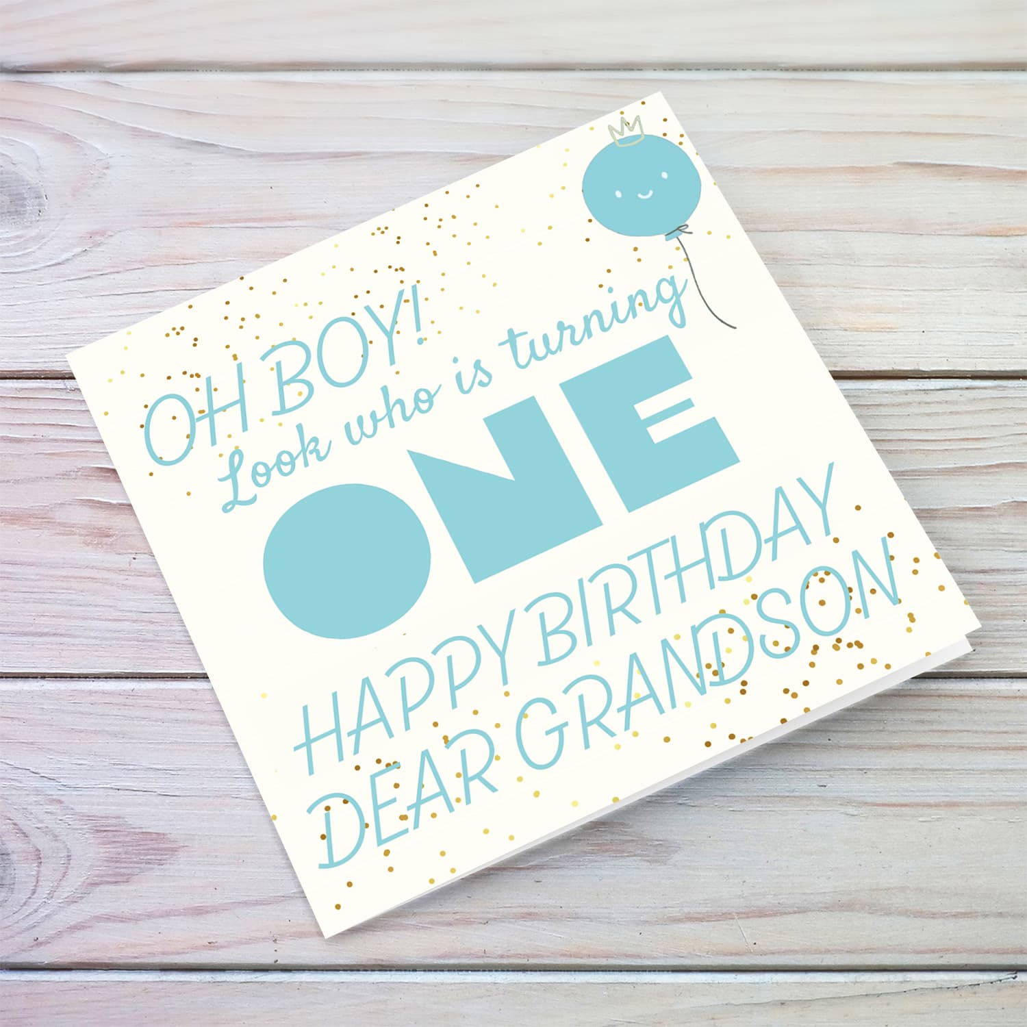 Look who's turning ONE - birthday card for a dear grandson with blue/turquoise text with cute balloon in English