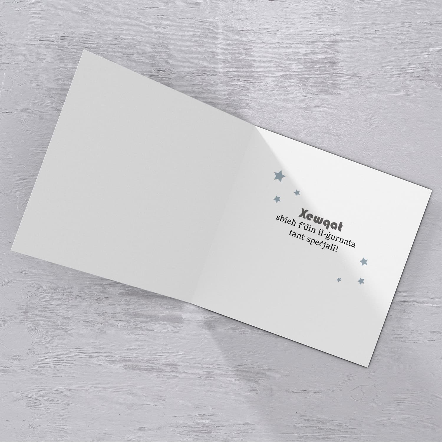 Blue with zigzag background and scattered stars birthday card for husband in Maltese