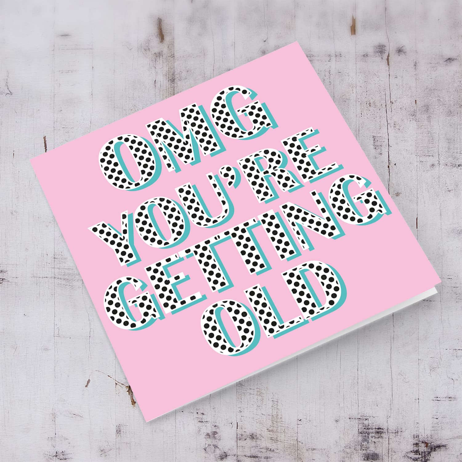Pink background with polka dot wording you're getting old birthday card in English