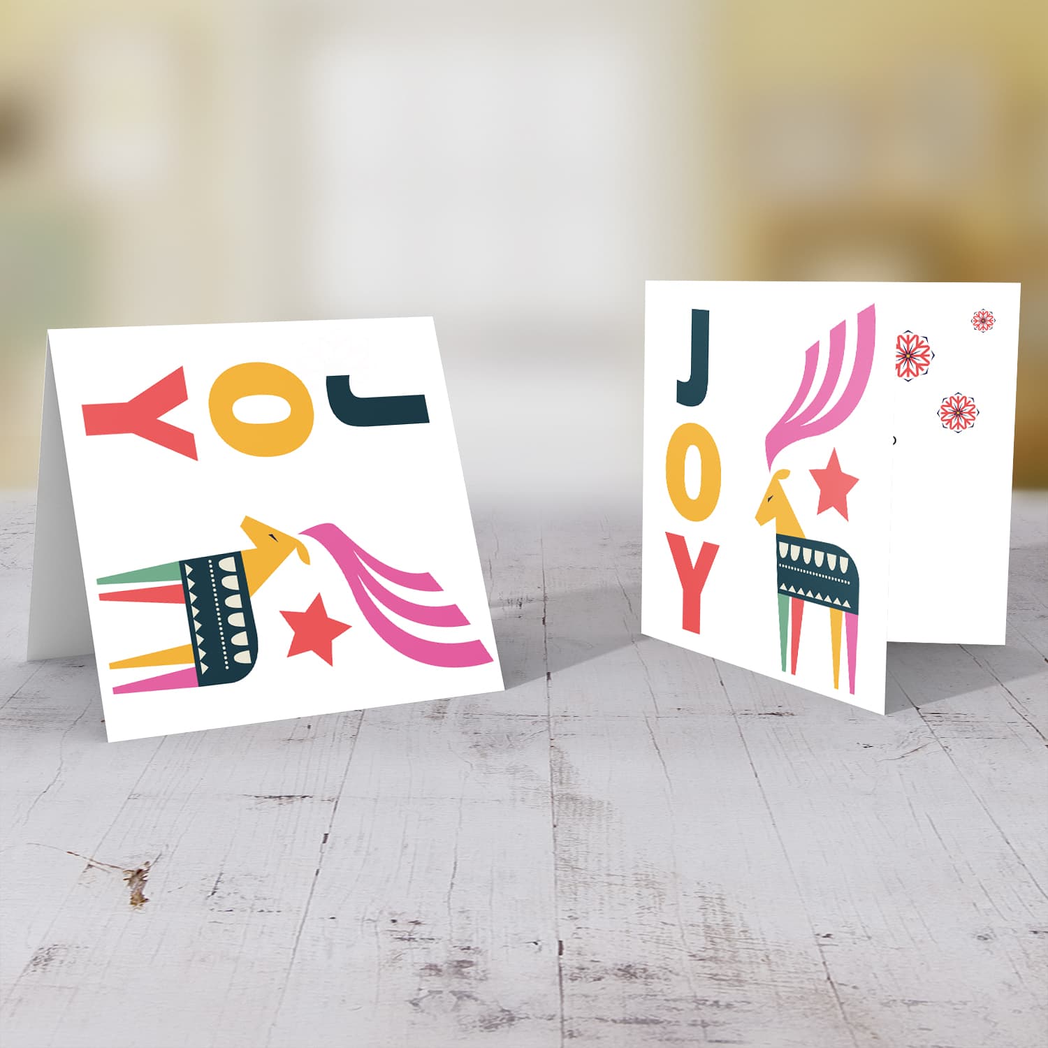 Reindeer themed Christmas card with the words JOY in English
