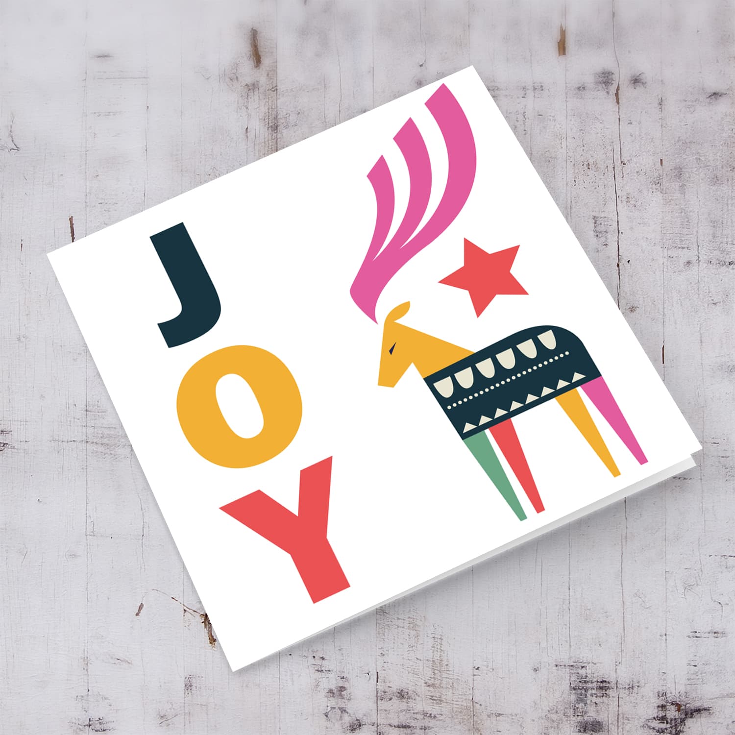 Reindeer themed Christmas card with the words JOY in English