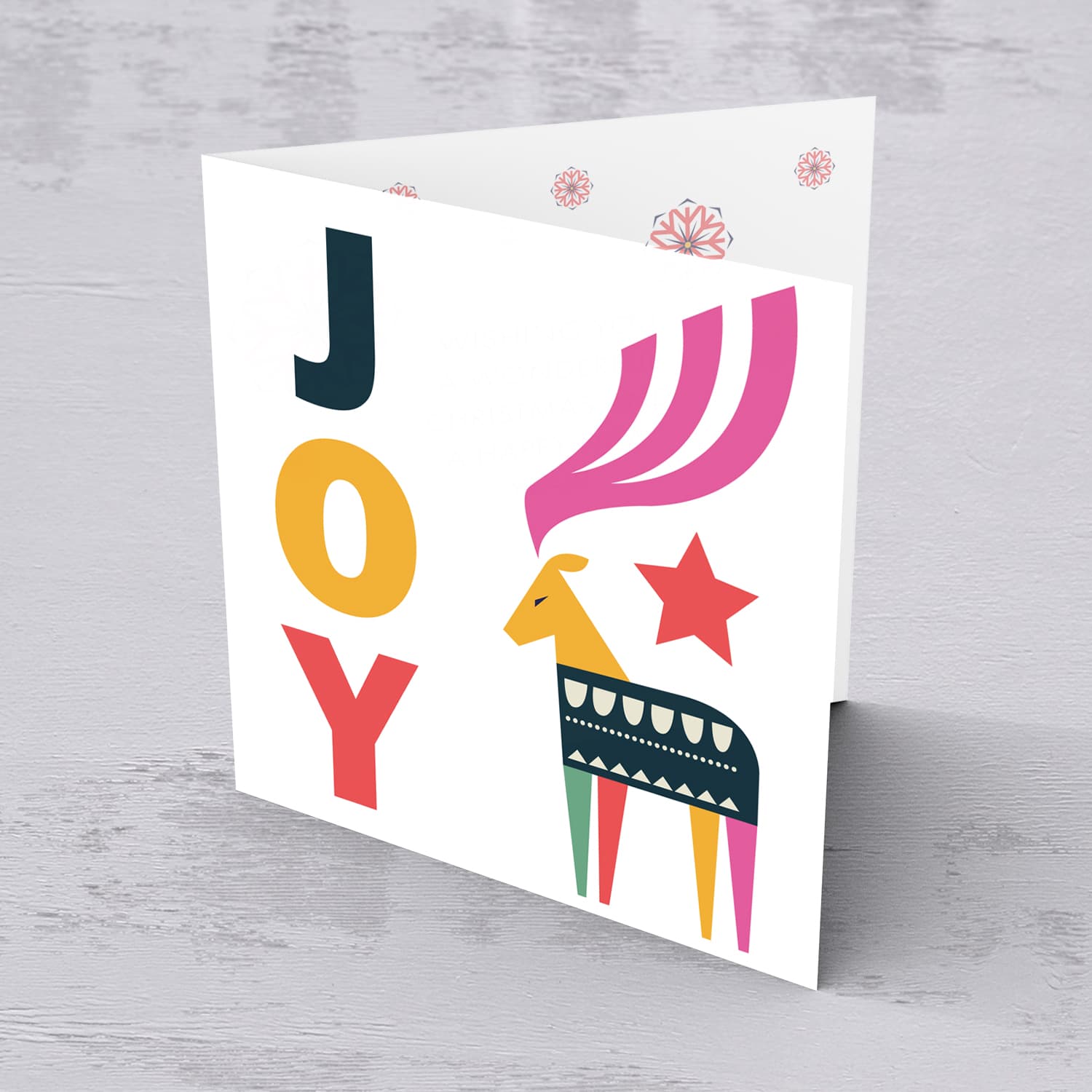 Reindeer themed Christmas card with the words JOY in English