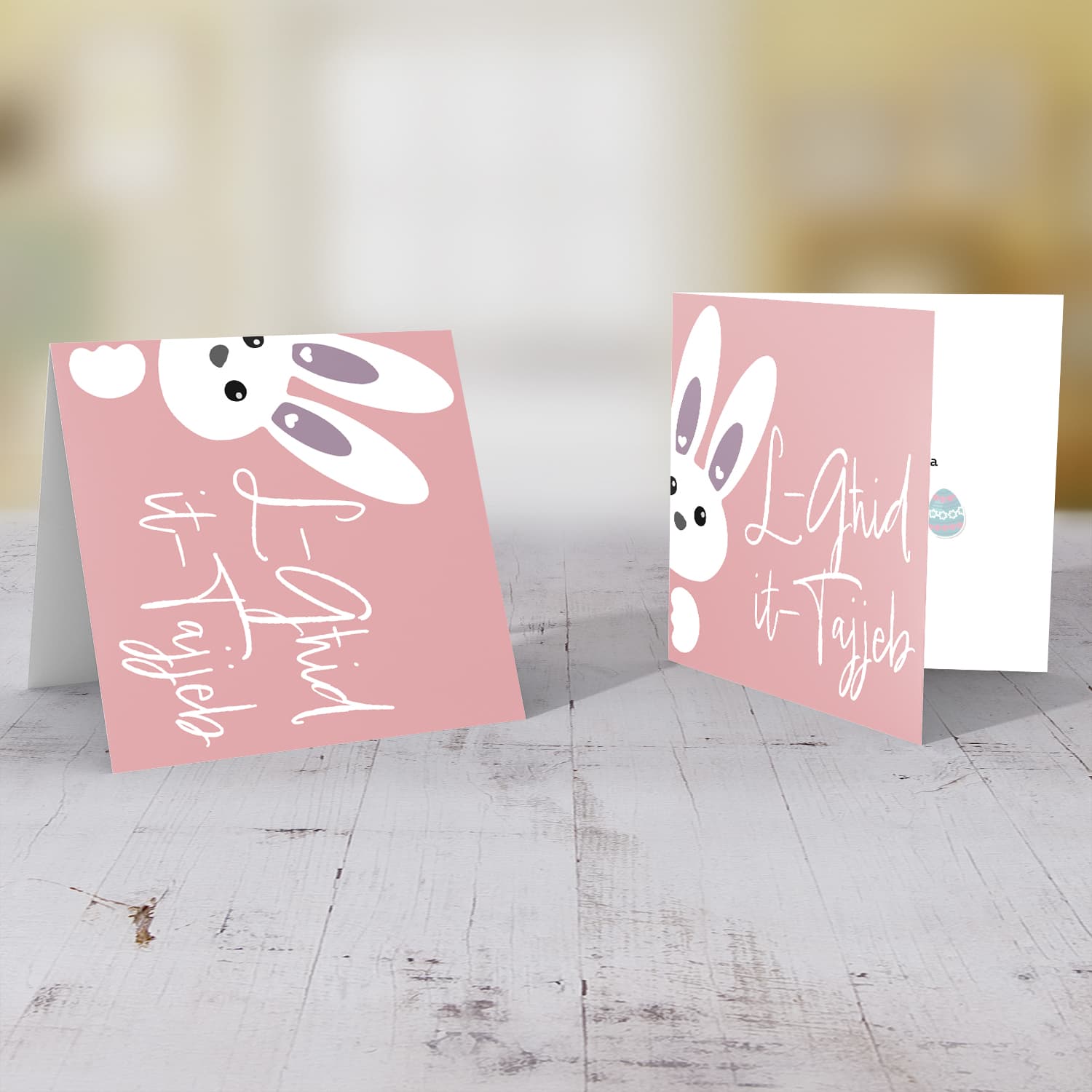 Cute bunny peeping out with pink background Easter Card in Maltese