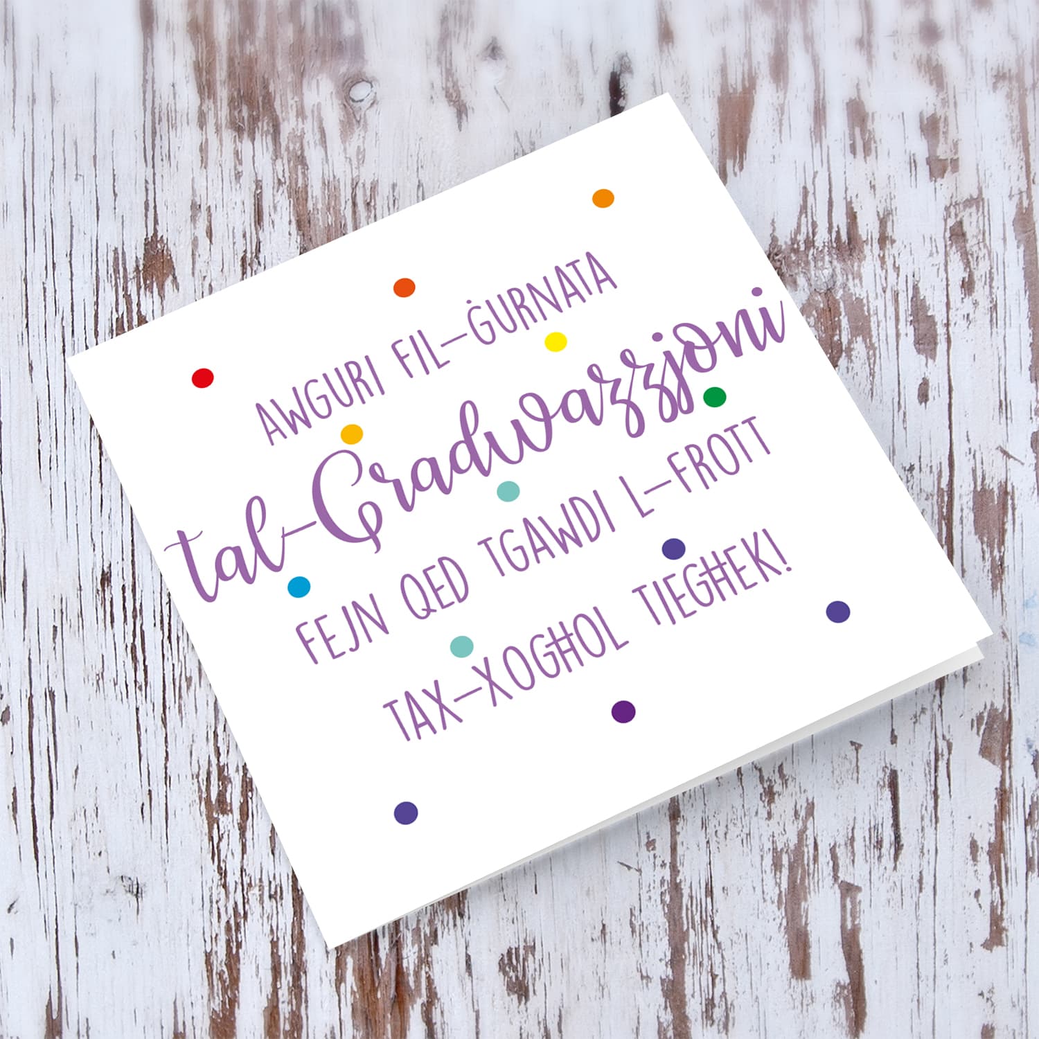 Colourful polka dot Graduation card in purple text in Maltese