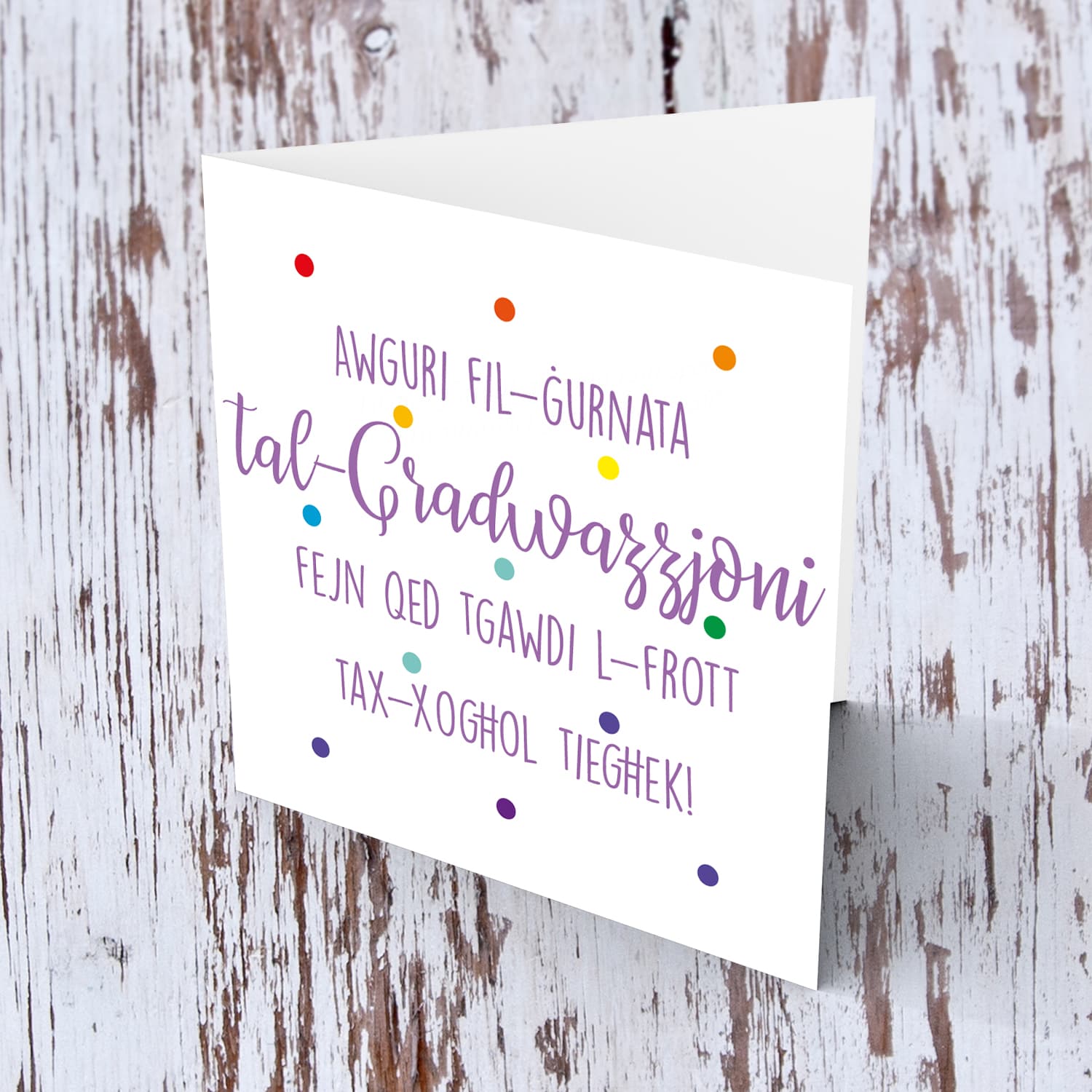 Colourful polka dot Graduation card in purple text in Maltese