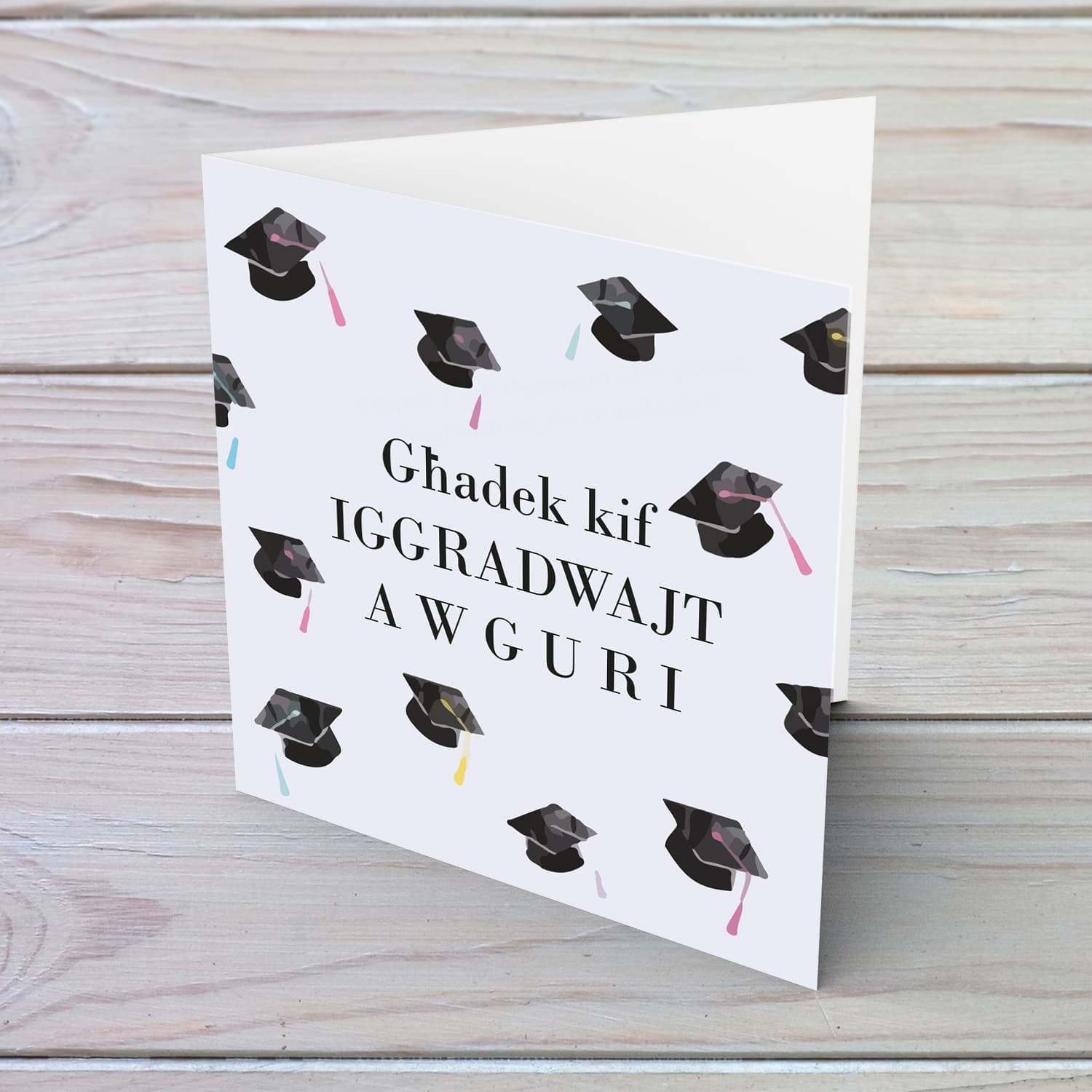 Graduation card with scattered party hats in Maltese