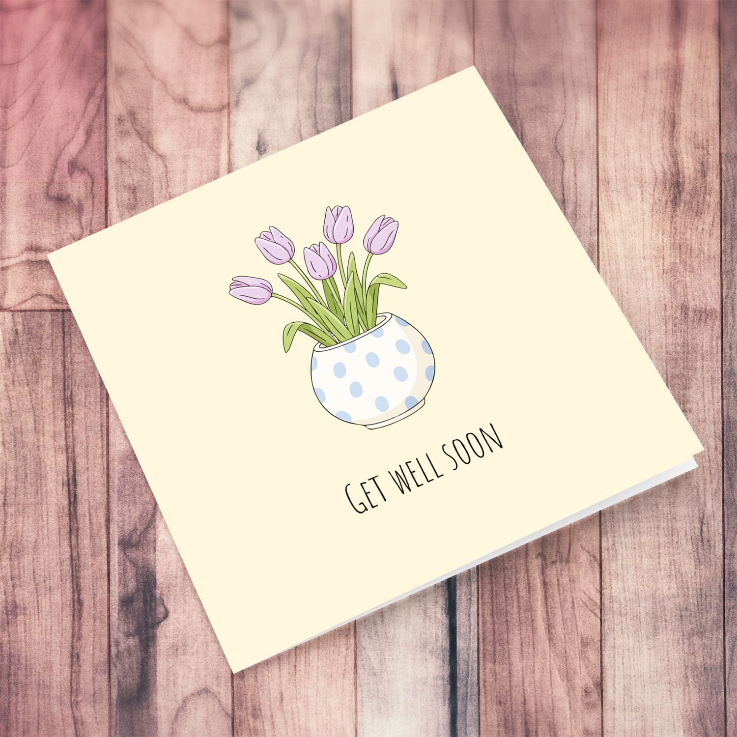 A beautiful get well soon card featuring light purple tulips in spotted vase and neutral background in English