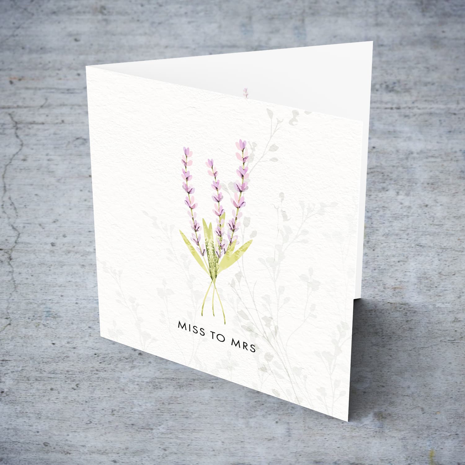A dainty minimalist hen party card, from Miss to Mrs, featuring a light purple floral detail in English