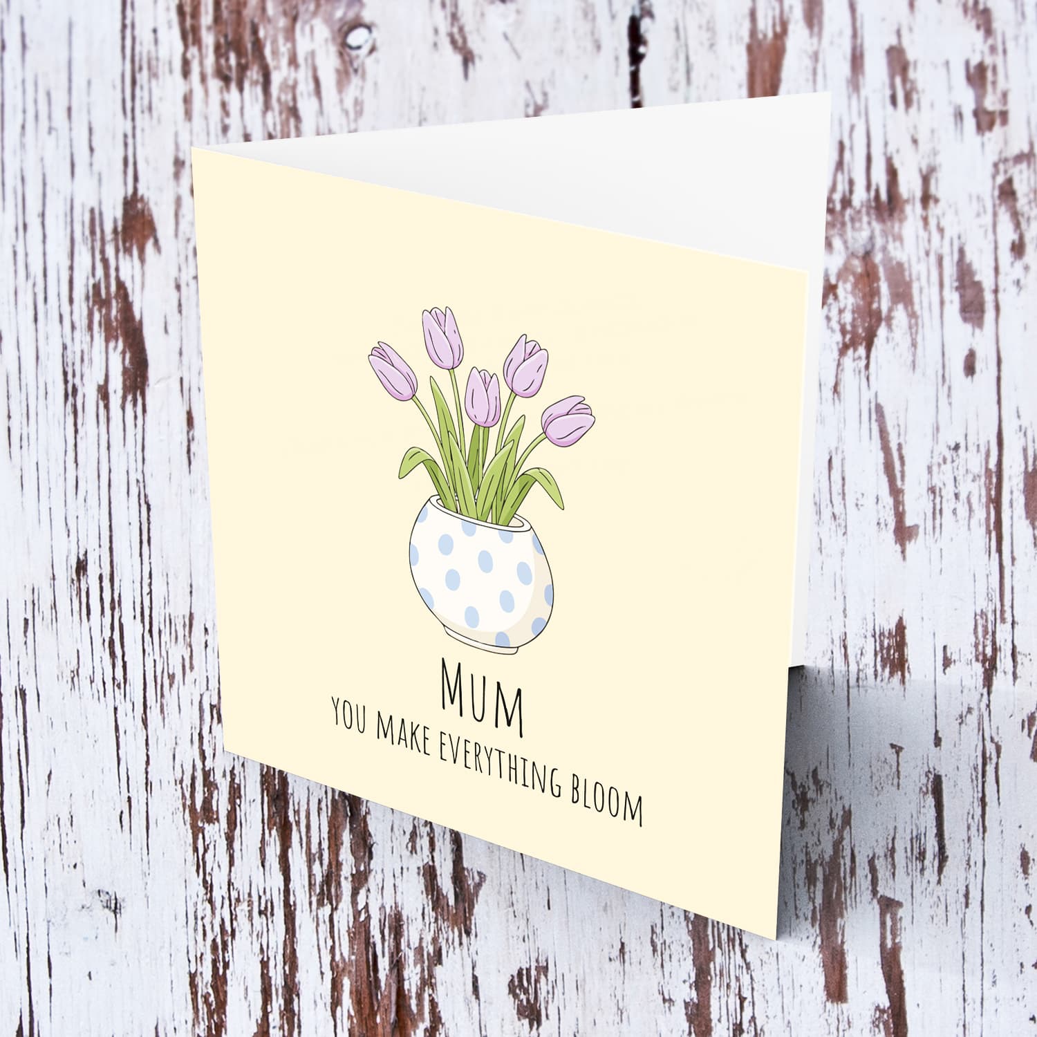 A beautiful mother's day card featuring light purple tulips in spotted vase and neutral background in English