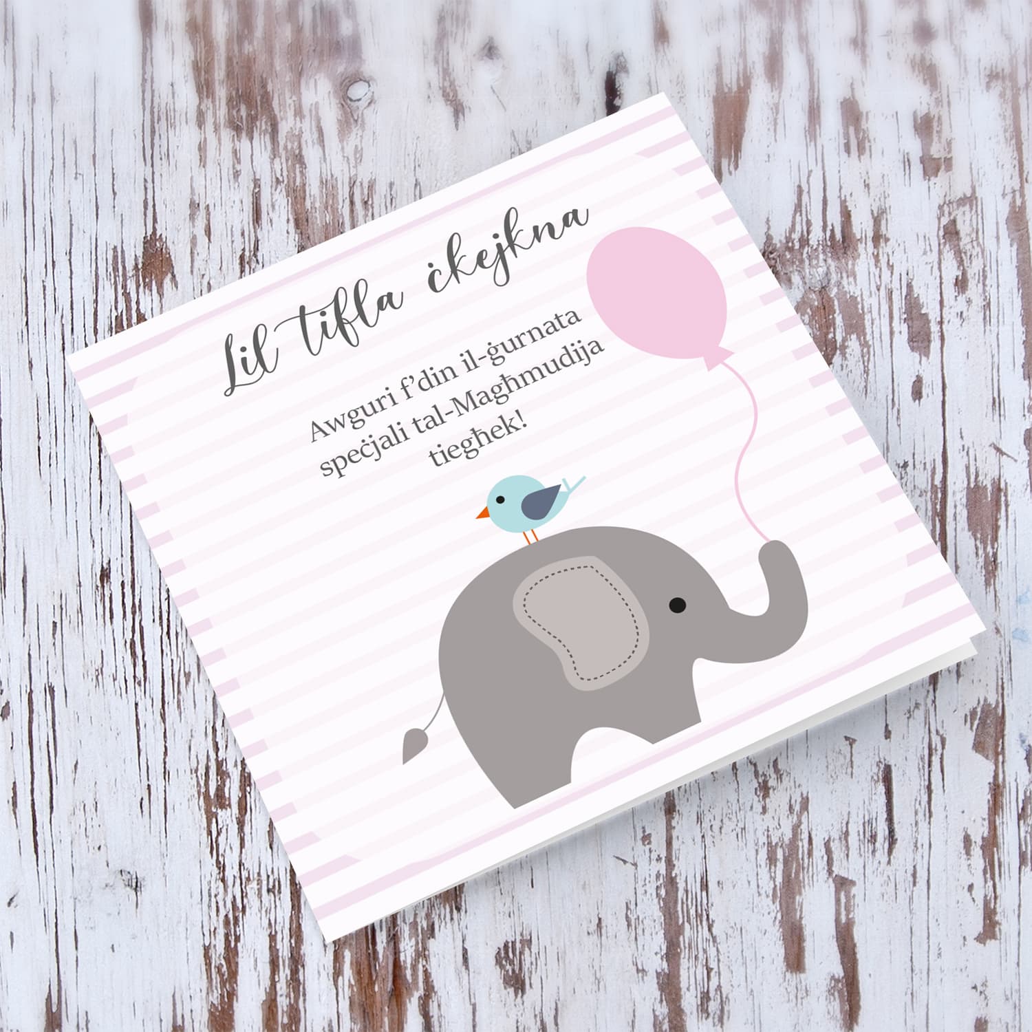 Pink striped background with elephant holding pink balloon baptism card for a little girl in Maltese