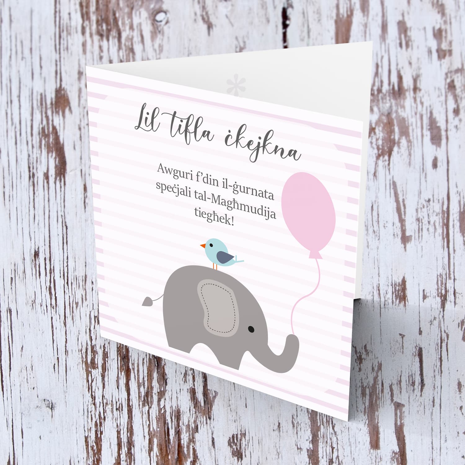 Pink striped background with elephant holding pink balloon baptism card for a little girl in Maltese