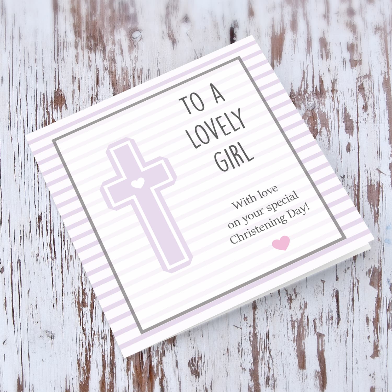 Pink striped background with a cross baptism card for a lovely girl in English