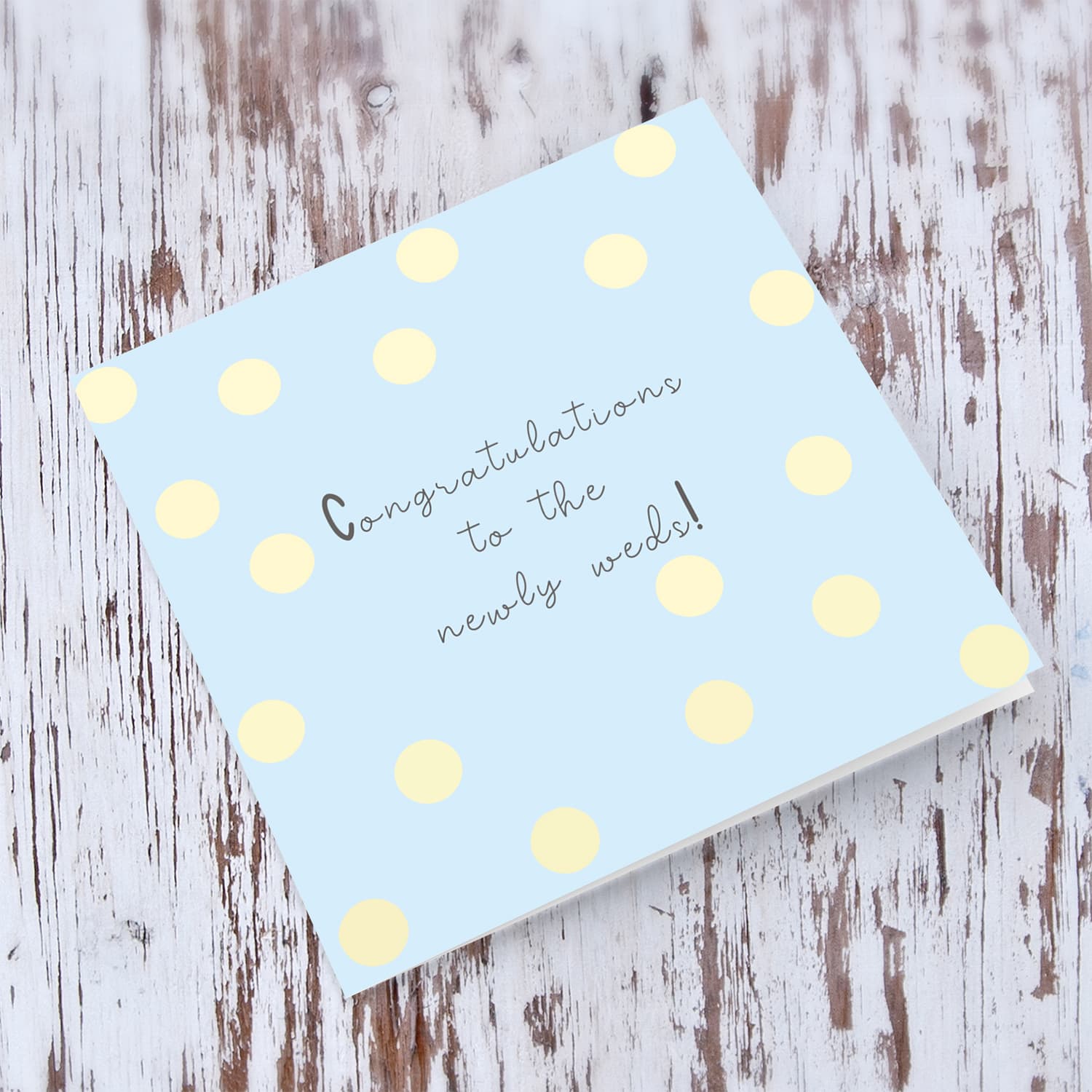 Light blue background with yellow spots wedding card in english