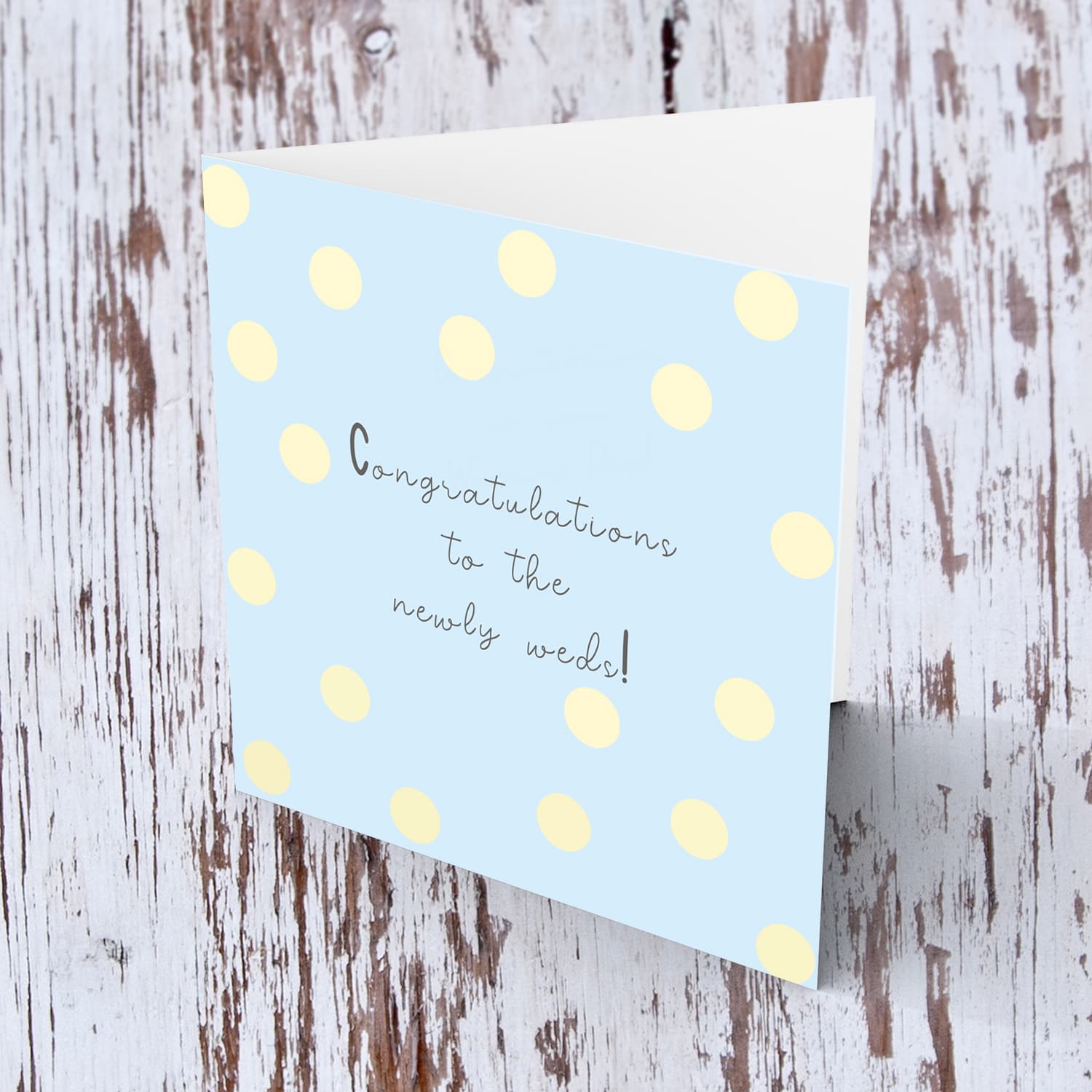 Light blue background with yellow spots wedding card in english