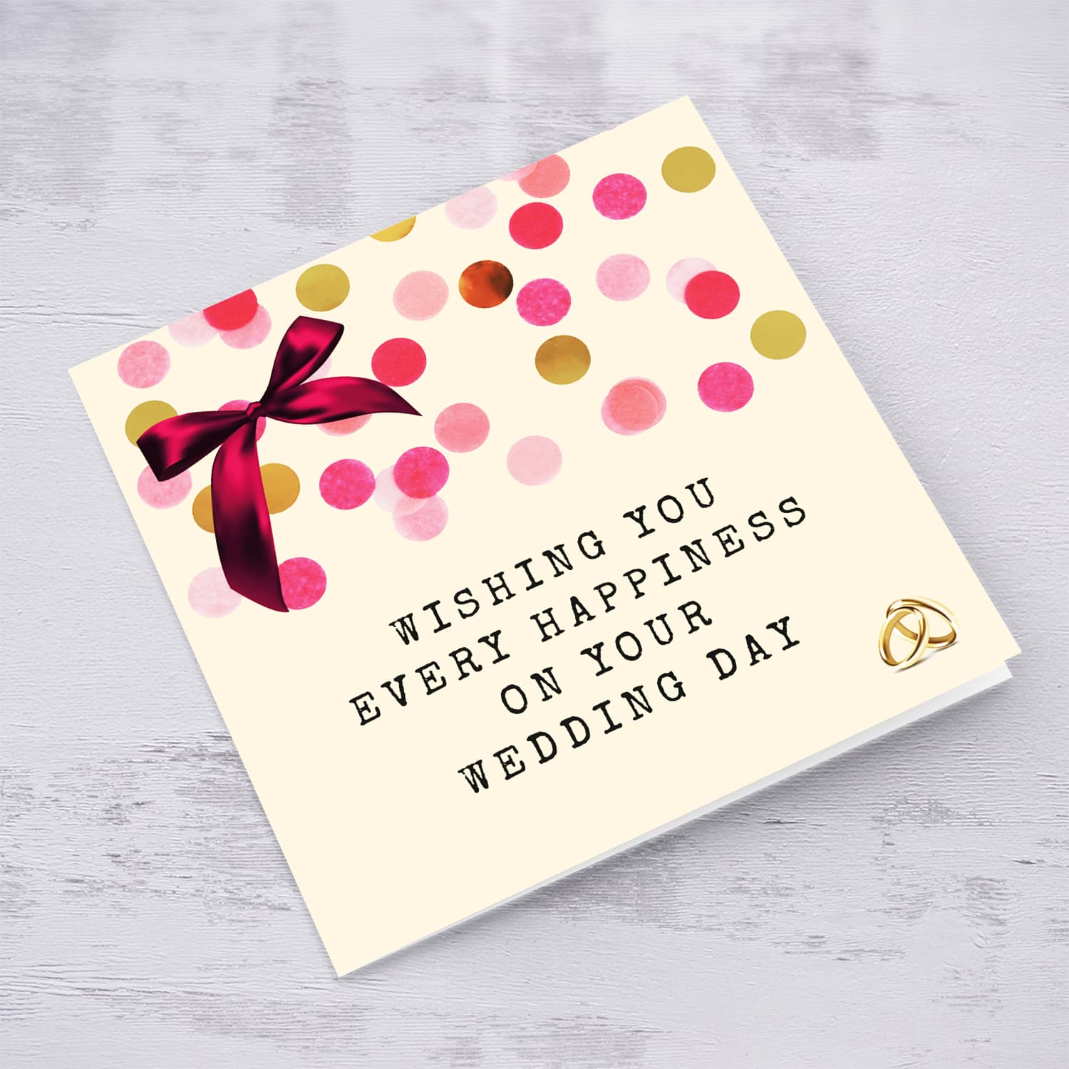 Cute wedding card with pink bow and scattered colourful confetti in English
