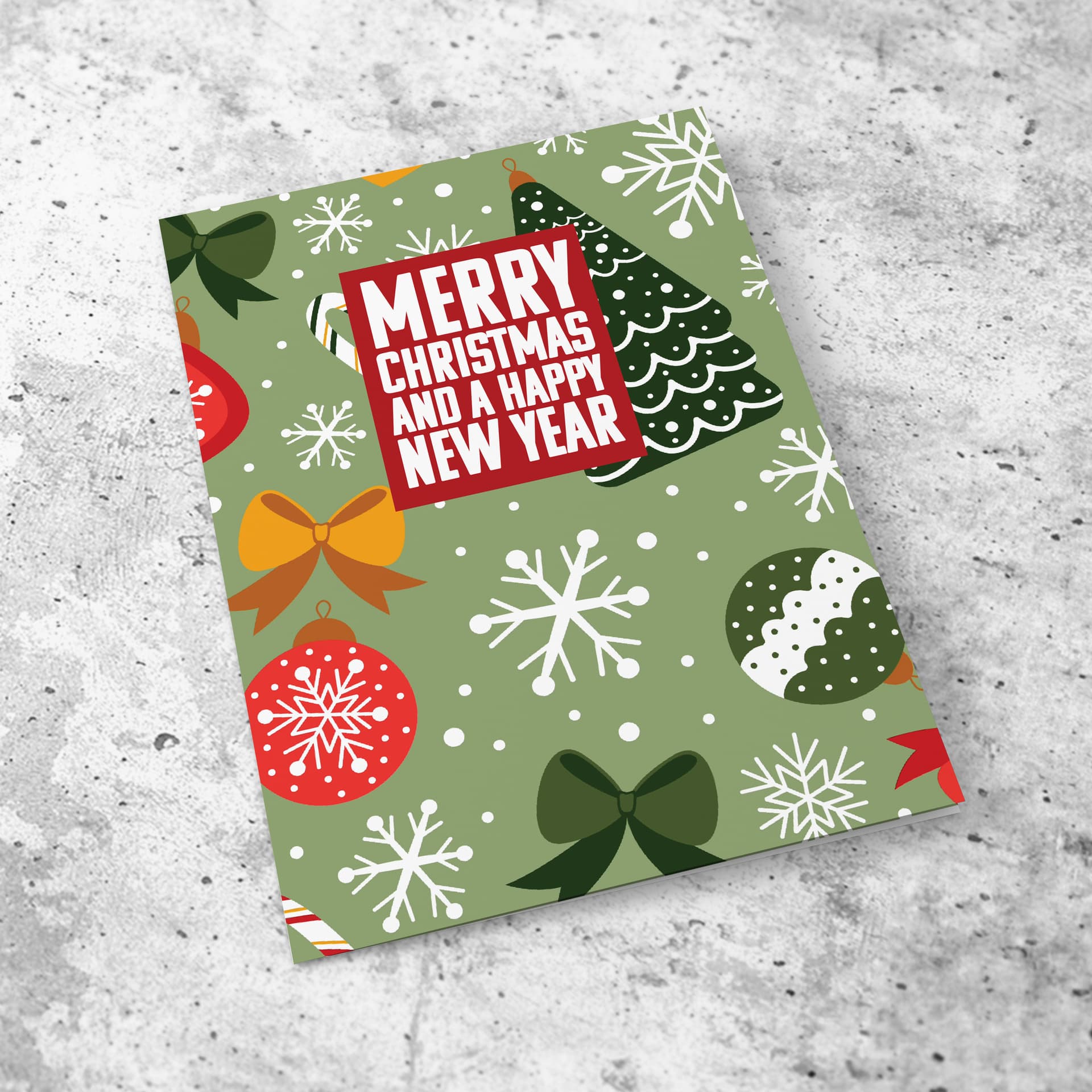 An open a5 Christmas card featuring a Christmassy background including baubles, bows and snowflakes in English