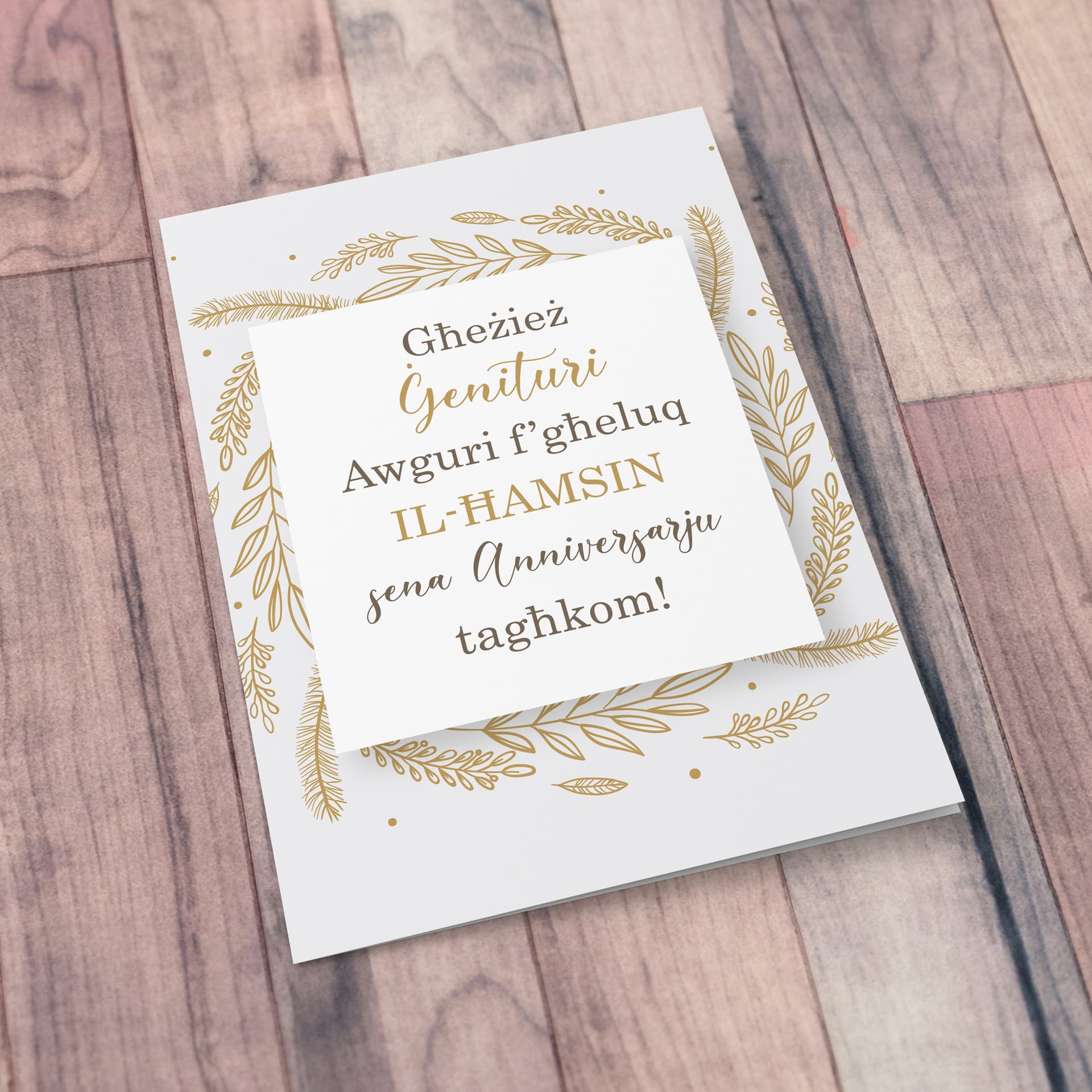 An A5 50th Wedding Anniversary card for parents with golden leaves border in Maltese