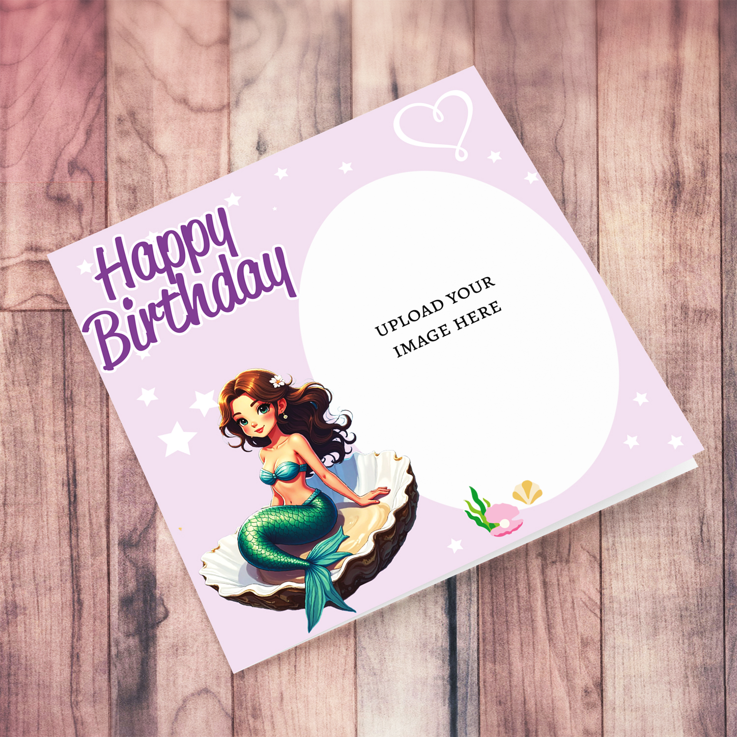 A cute photo birthday card in light pink background with a brunette mermaid, sitting in an oyster shell in English