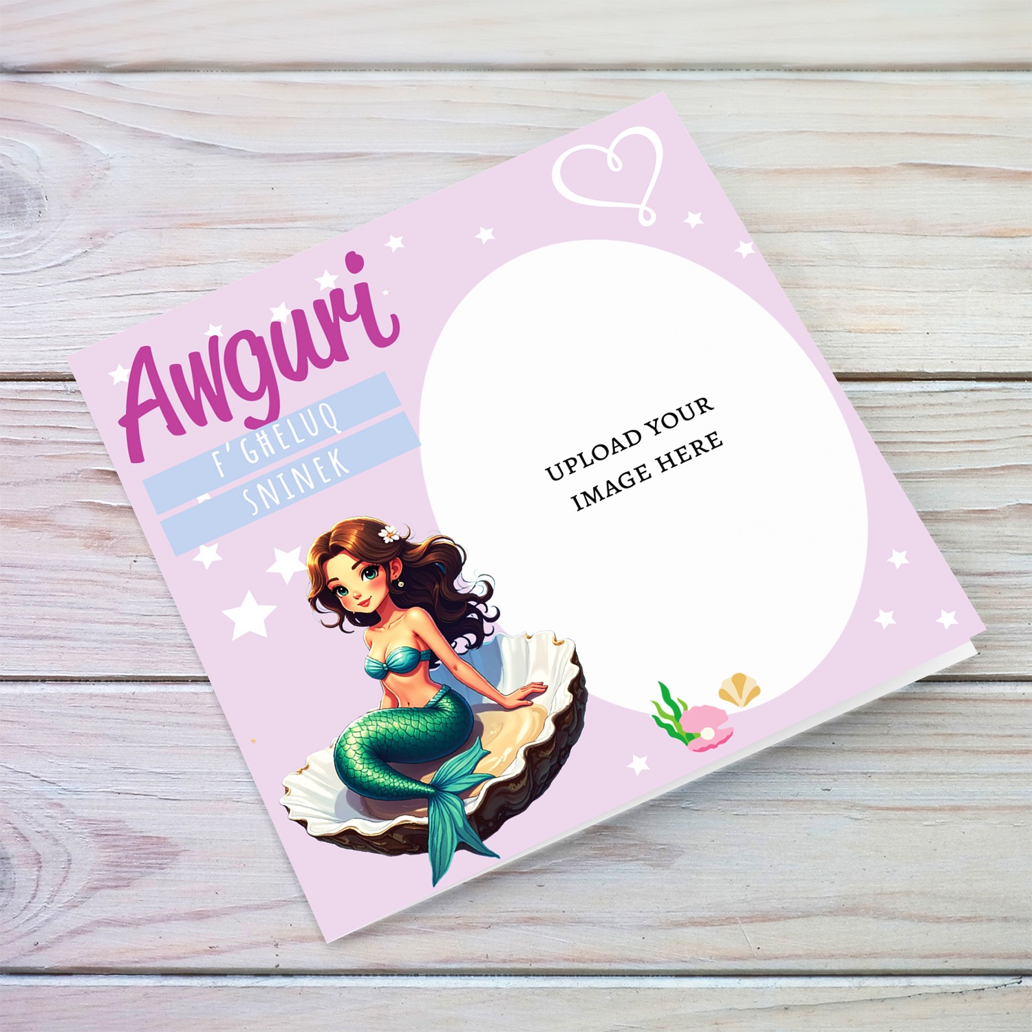 A cute photo birthday card for girls in light pink background with a brunette mermaid, sitting in an oyster shell in Maltese