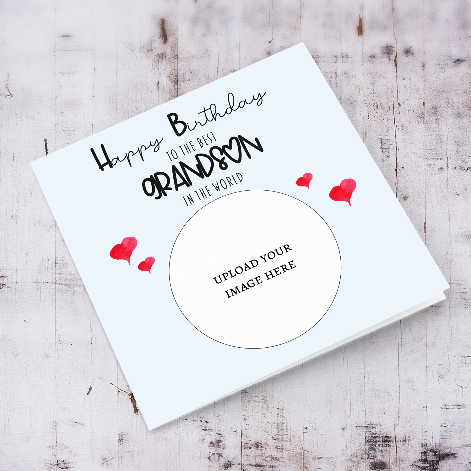 A light blue coloured photo birthday card to the best grandson in the world with small red hearts in English