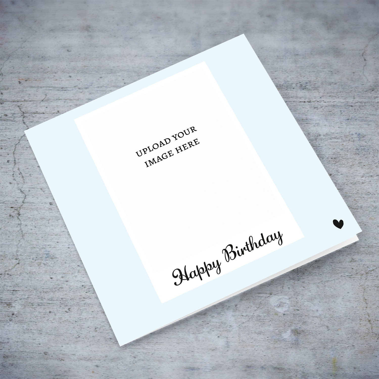 Light blue background photo birthday card in English with small black heart 