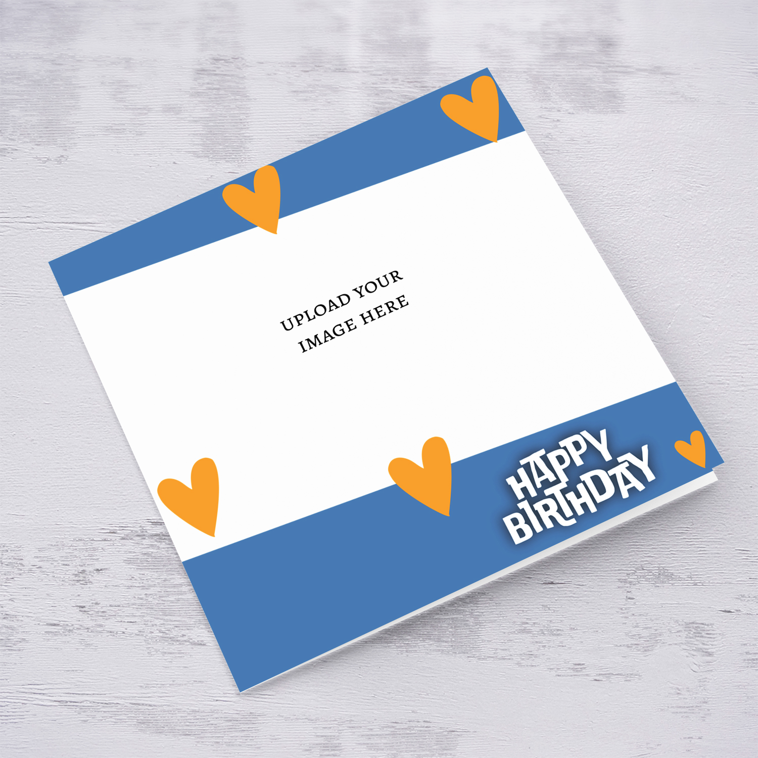An open photo birthday card with touches of blue and orange scattered hearts in English