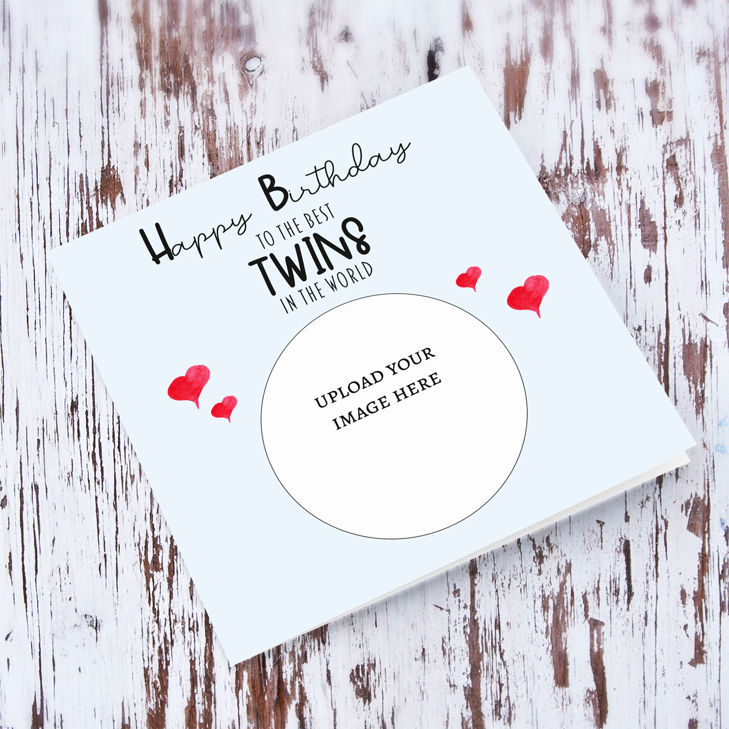 A light blue coloured photo birthday card to the best twins in the world with small red hearts in English