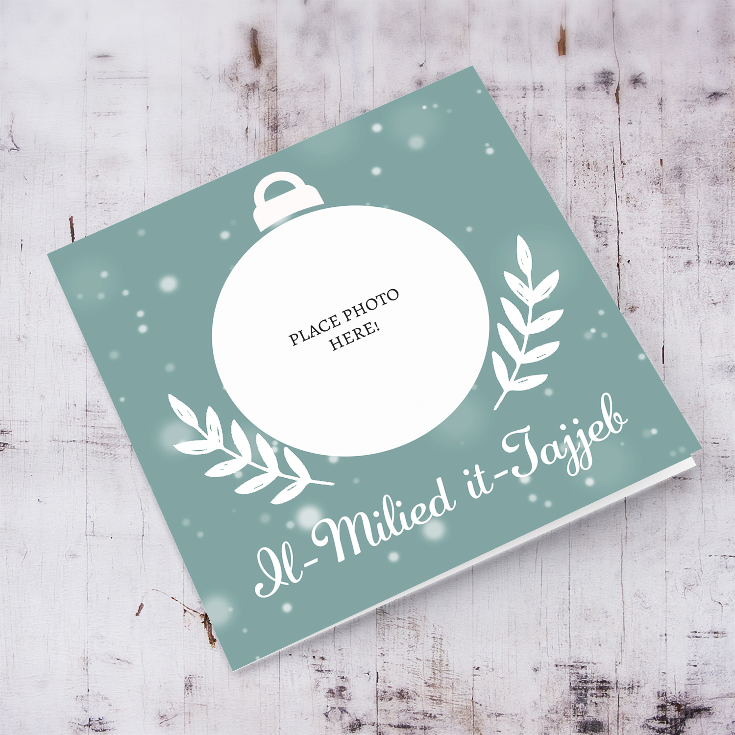 Turquoise monochrome bauble themed Christmas photo card with falling snow and white leaves in Maltese