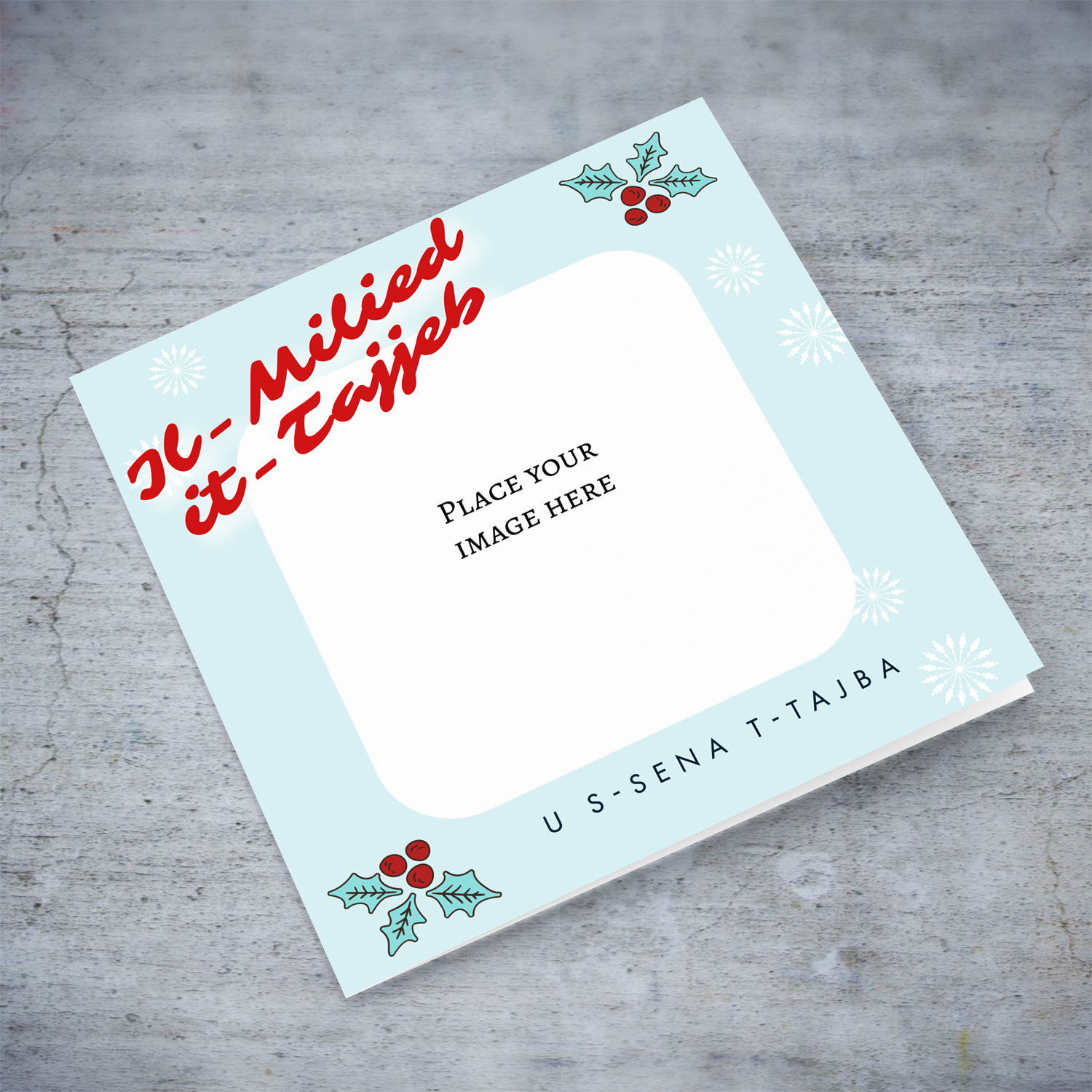 Photo open Christmas card with light blue background, christmas hollies, and scattered white snowflakes in Maltese