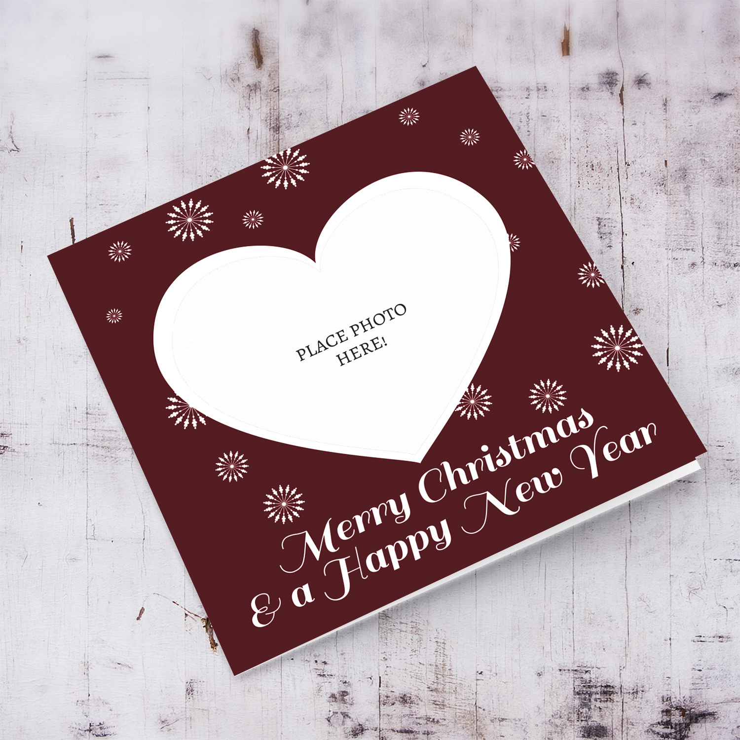 Heart shaped open Christmas card in dark red background in English
