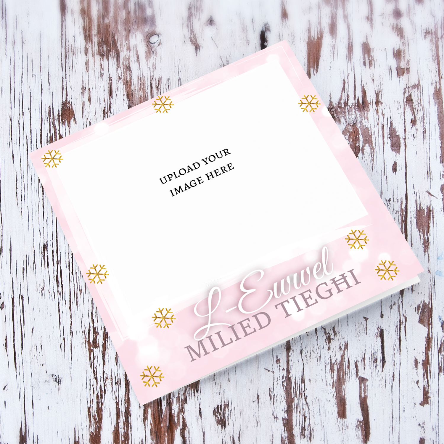 First Christmas photo greeting card in a light pink background with scattered golden snowflakes in Maltese (Blank Message Inside)