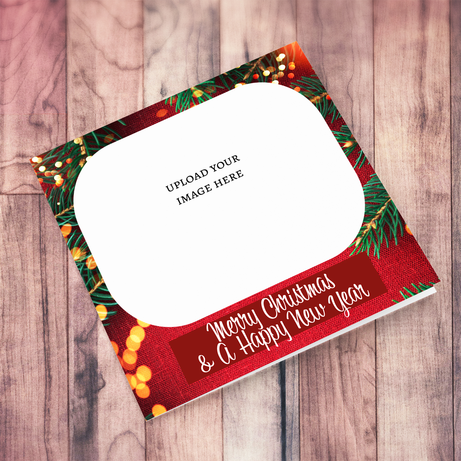 A traditional background photo Christmas card featuring a red background, tree branches and Christmas lights wishing a Merry Christmas and a Happy New Year in English