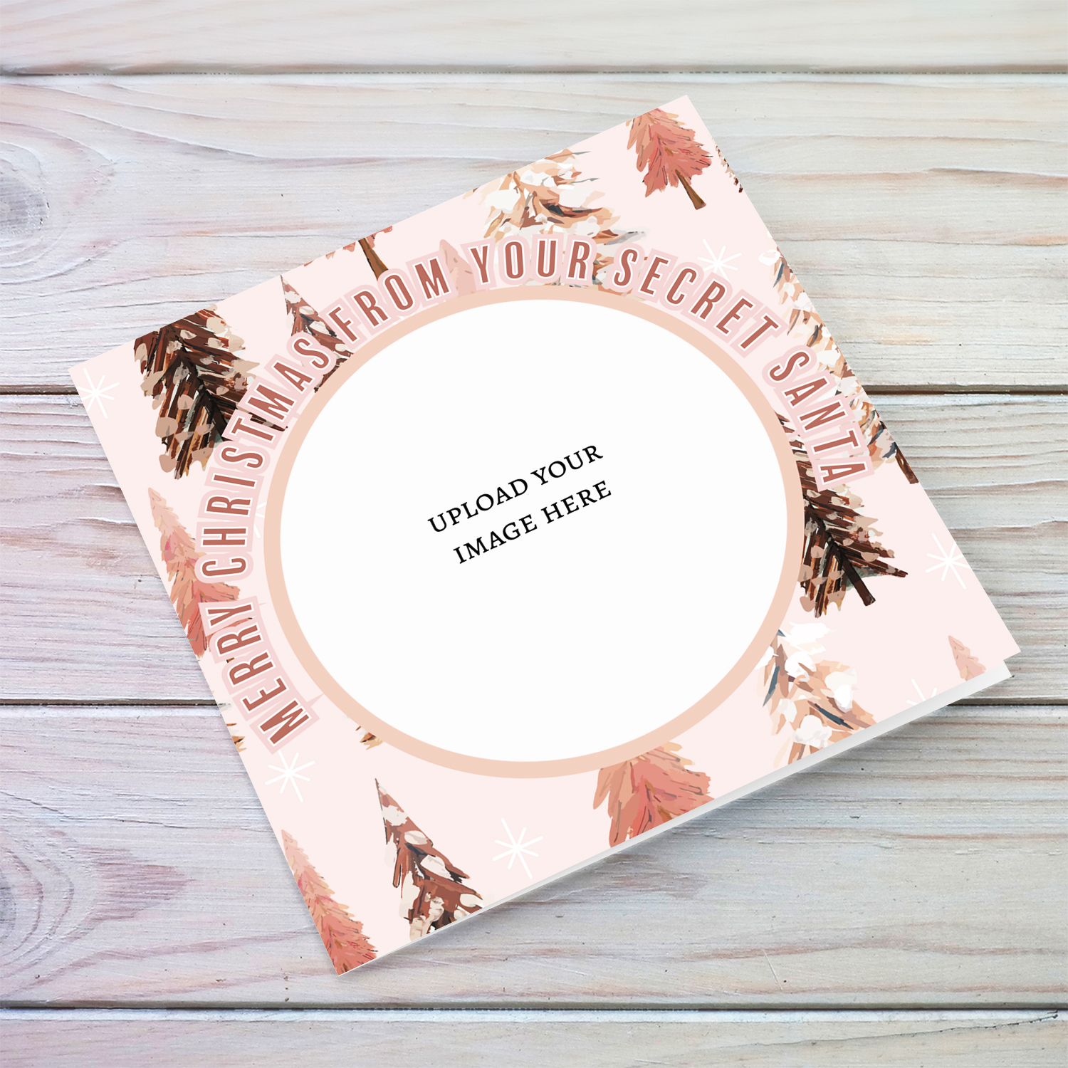 A Christmas card in various pink tones, featuring a background with different Christmas trees - Secret Santa Card in English