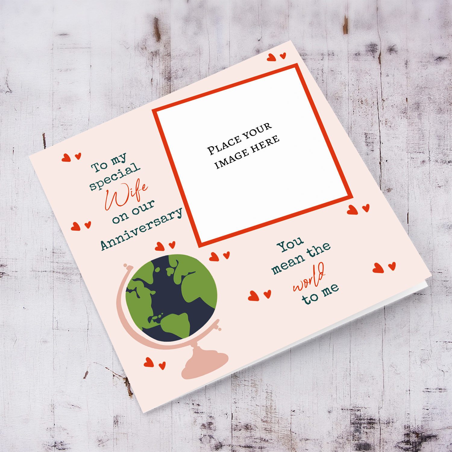 A romantic photo anniversary card for Wife - You mean the world to me - in light pink background, scattered hearts and a globe in English