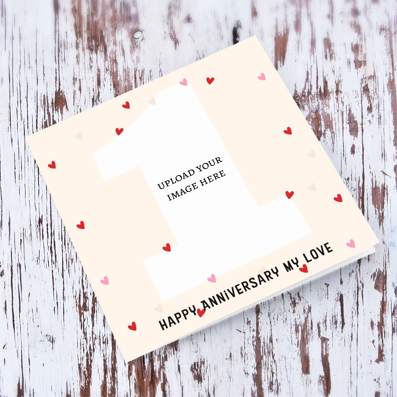 1st Anniversary first shaped photo in cream background with scattered hearts in English