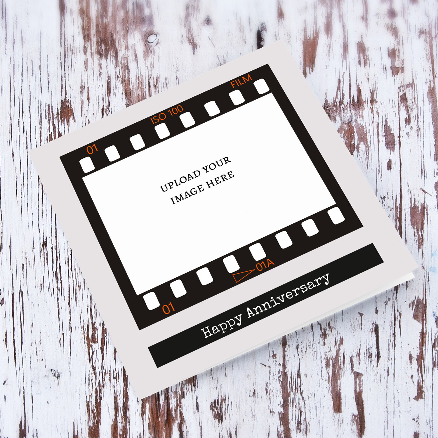 A photo Anniversary card featuring a black photo film reel to upload photo into and a neutral background in English