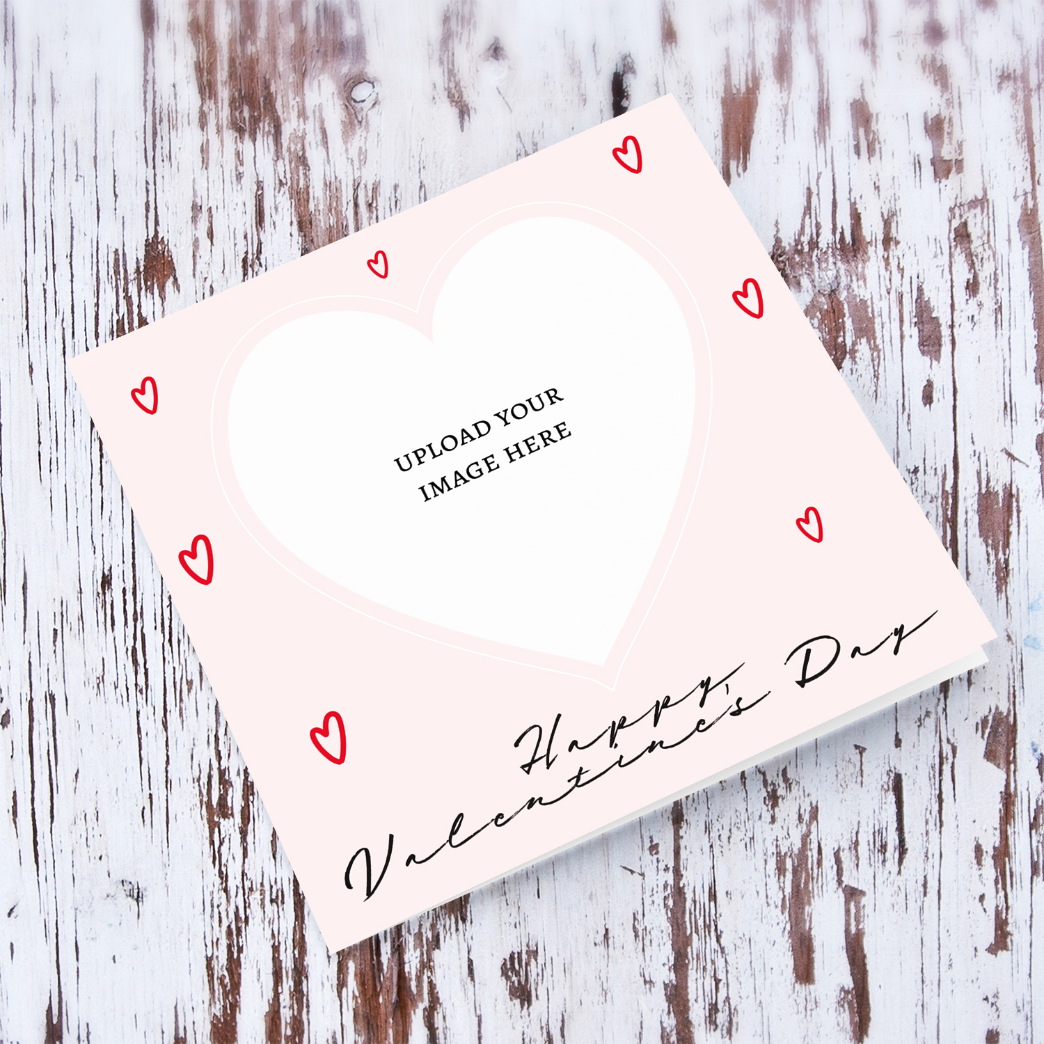 A pink background Valentine's day photo card with scattered red hearts in English