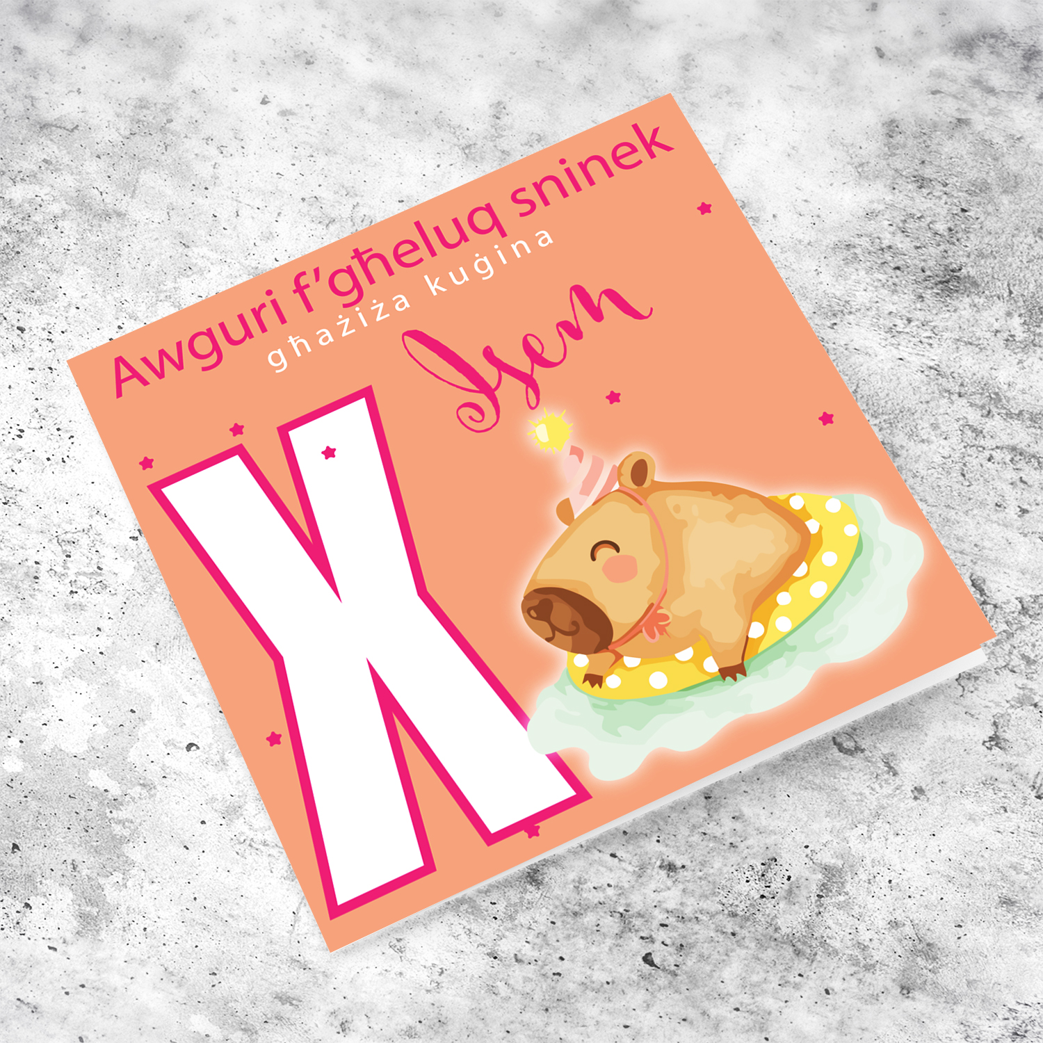 A cute birthday card for cousin featuring a capybara swimming and wearing a party hat, personalisable with name and age in pink tones in Maltese (Personalisable + Enter Age)